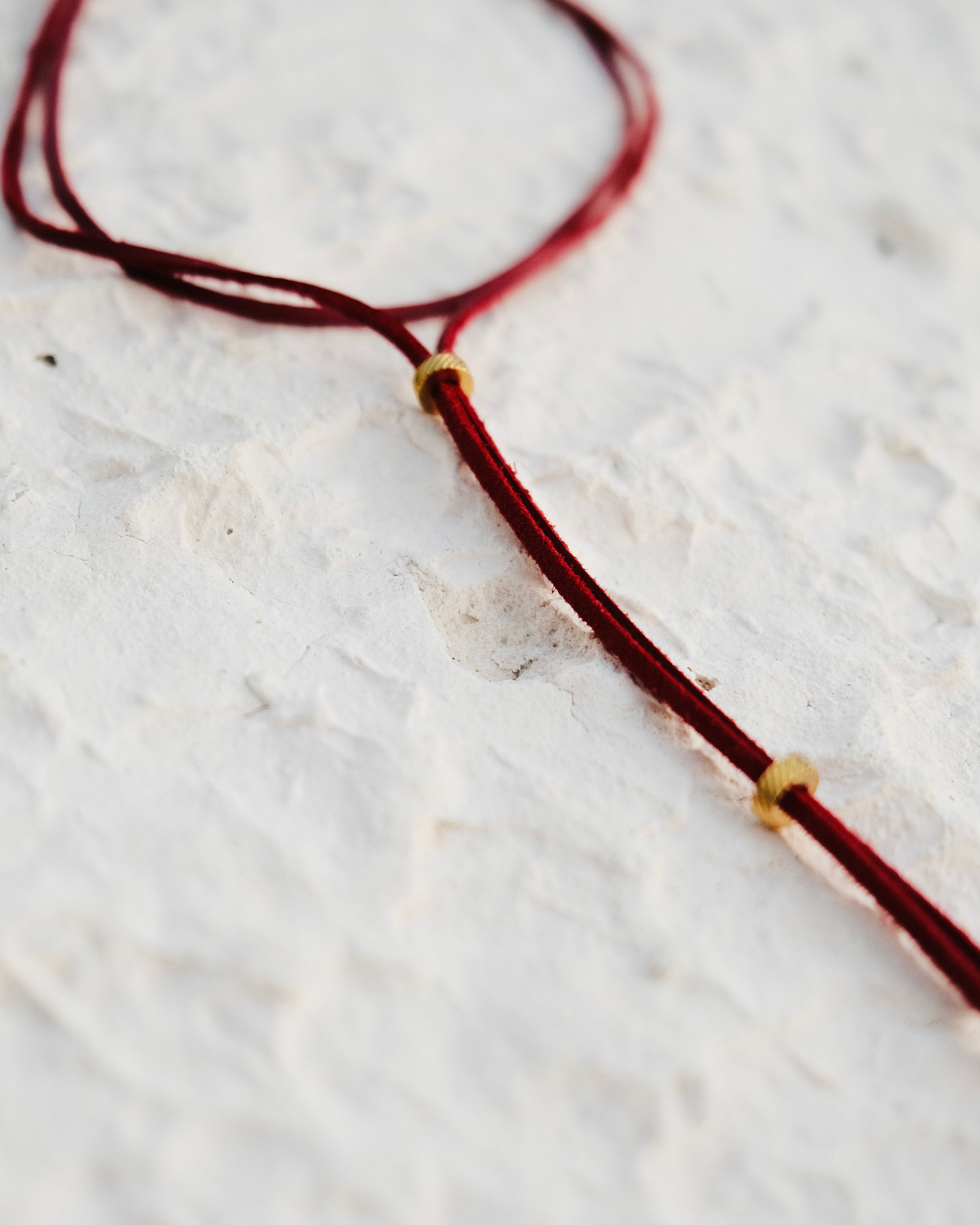 Carmine vegan leather link, enhanced with stainless steel beads. Fiery, assertive, hypnotic.