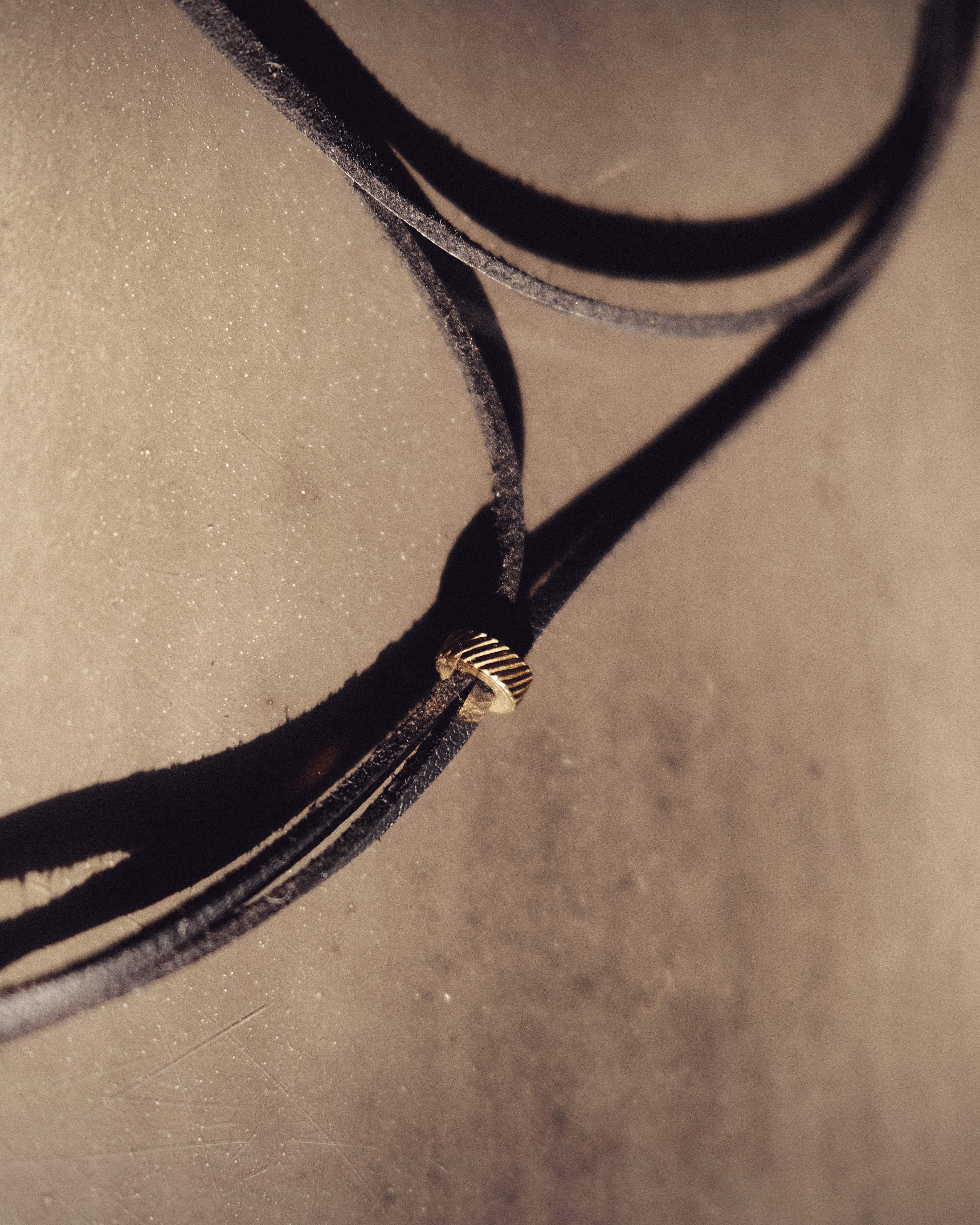 Black vegan leather cord, embellished with stainless steel beads. Bold, timeless, sensual.